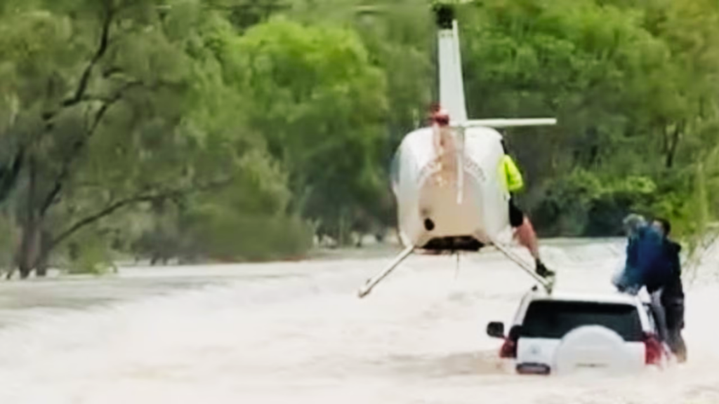 Helicopter Pilot Drops Police Officer Onto Flooded Car to Save Stranded Pair in Katherine
