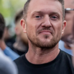 Tommy Robinson Says He Was Detained at Heathrow as Police Seize His Phone Amid Fallout From NI Riots